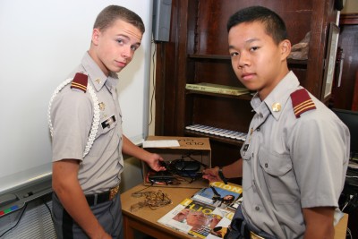 Fishburne Military School Cadets Jacob Fincham (Fredericksburg, VA) and Matthew Sim (Henrico, VA) show off box of glasses already collected for needy.