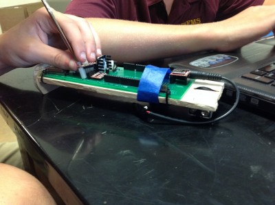 Fishburne Military School cadet repairs rocket board at West Virginia University rocketry camp