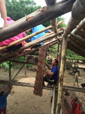 Cadet Raymond Dua assists as villagers and volunteers extend the roof of a local building