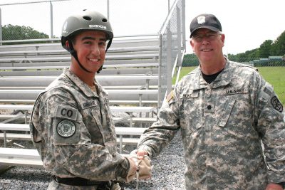 Fishburne SAI, LTC Robert Hunt, congratulates Cadet Alex Ralston who earned command of B Co. during JROTC 4th Brigade's JCLC Eagle