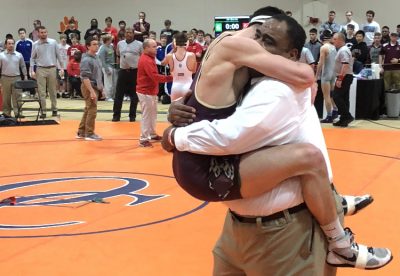 Fishburne Military School's Matthew Farrar and Coach Terry Waters celebrate Farrar's State Championship (120lbs)